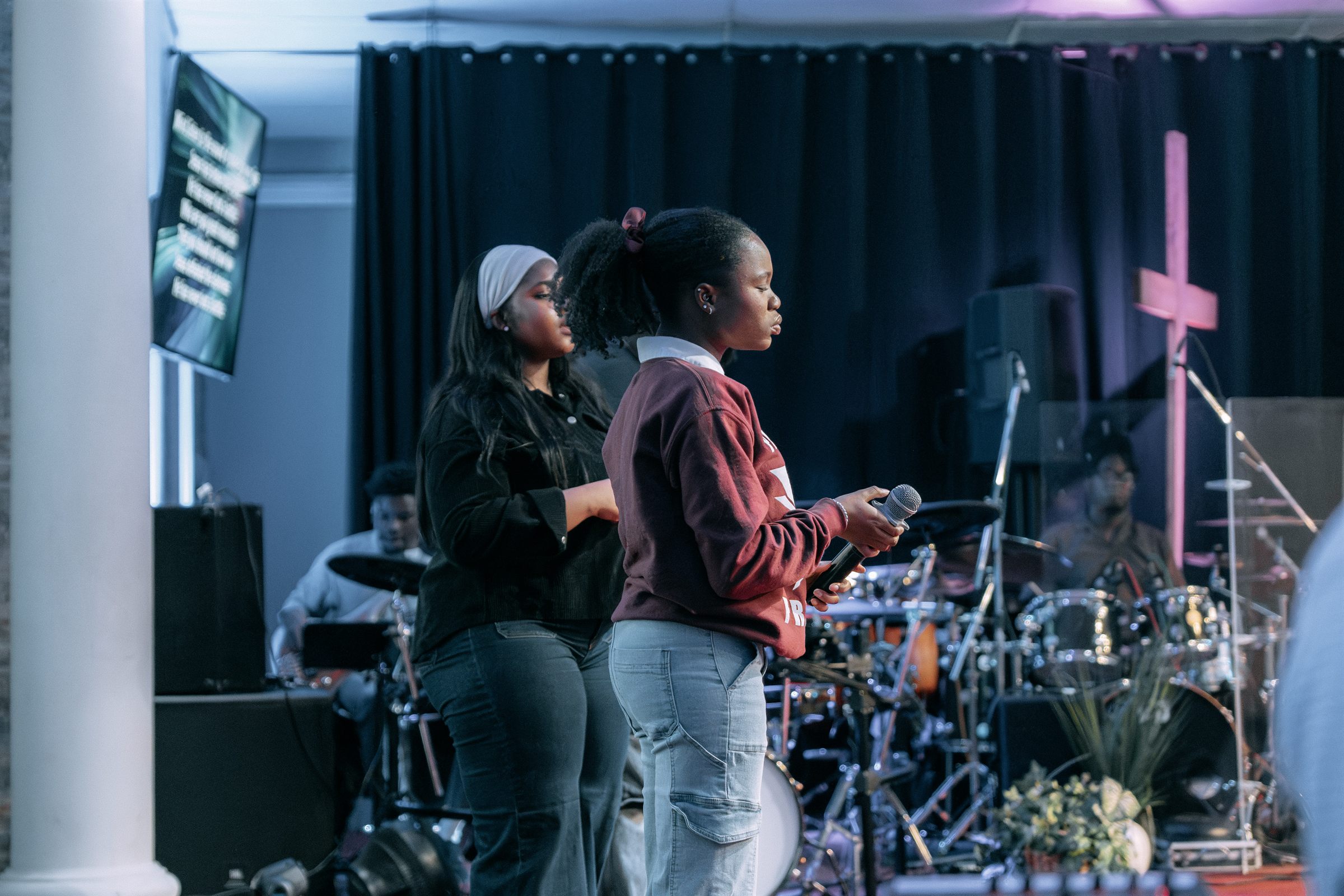 OneVoice leading worship, singers at the mic with the band behind them
